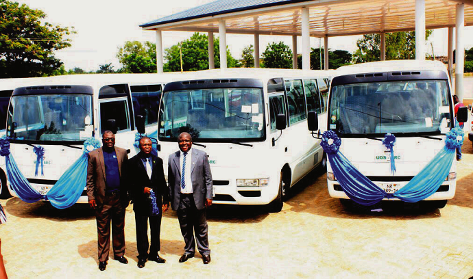 Mr Dzomeku (middle) holding the keys to the buses. With him are Mr Amponfi-Duku (right) and an employee of the bank